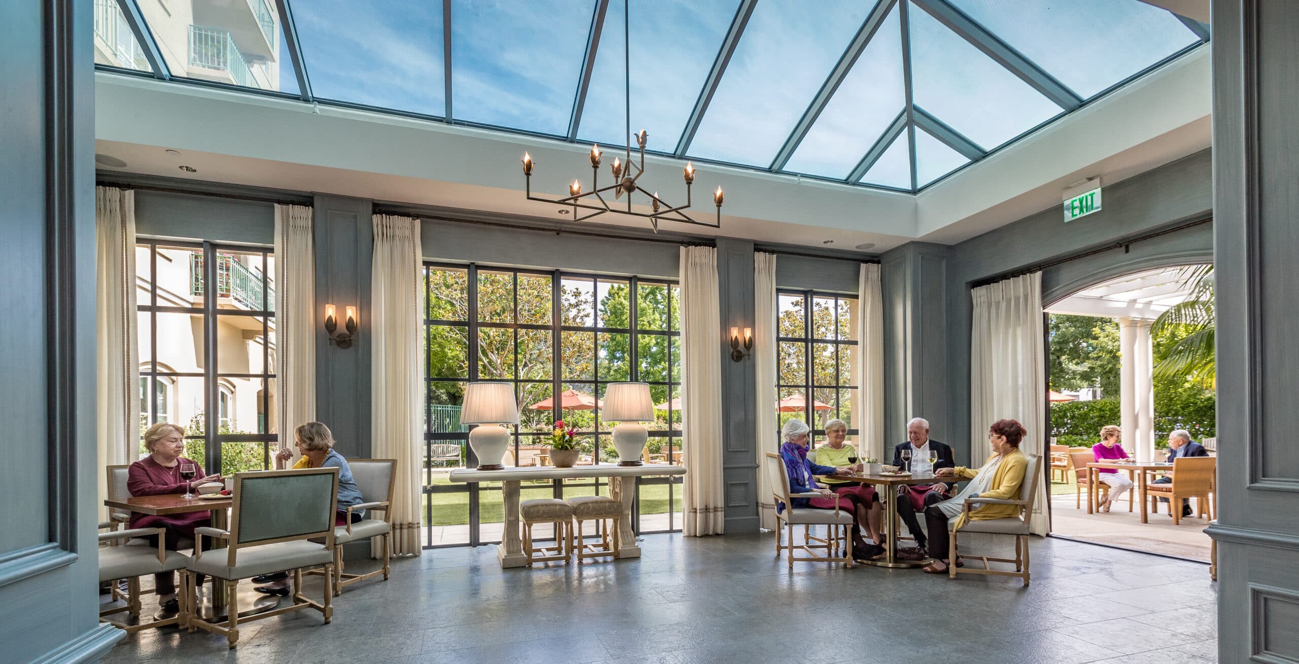 The Peninsula Regent indoor and outdoor atrium, where older adults gather and talk